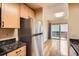Efficient kitchen layout with stainless steel refrigerator and granite countertops, leading to a bright and airy breakfast nook at 8040 Holland Ct # C, Arvada, CO 80005
