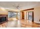 Bright living room with hardwood floors, a brick fireplace, and large windows for natural light and outside views at 8040 Holland Ct # C, Arvada, CO 80005