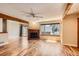 Spacious living room featuring a brick fireplace, hardwood floors, and sliding glass door access to the outside at 8040 Holland Ct # C, Arvada, CO 80005