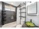 Bathroom featuring black marble style tile, green glass sink, open shelving, and shower at 7450 Granada Rd, Denver, CO 80221