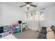 Neutral bedroom with a playful play area, a sofa, and bright windows with plenty of natural light at 7450 Granada Rd, Denver, CO 80221