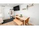 Cozy dining area with modern table and seating, adjacent to the entrance and featuring minimalist decor and ample light at 7450 Granada Rd, Denver, CO 80221