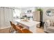 Modern kitchen with white cabinets, stainless steel appliances, a center island, and stylish bar stools at 7450 Granada Rd, Denver, CO 80221