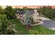 Aerial view of the home with beautiful landscaping, a pond, and spacious yard with mature trees at 10145 Meadow Run, Parker, CO 80134
