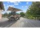 Spacious back deck featuring outdoor seating and beautiful views of the surrounding landscaping at 10145 Meadow Run, Parker, CO 80134