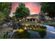 Scenic backyard view with a tranquil pond and stone waterfall feature, creating a serene outdoor space at 10145 Meadow Run, Parker, CO 80134
