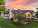 Spacious backyard featuring a patio, beautiful brickwork, manicured lawn, and mature trees at 10145 Meadow Run, Parker, CO 80134