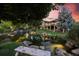 Tranquil backyard featuring a serene pond with a waterfall and a comfortable bench for relaxation at 10145 Meadow Run, Parker, CO 80134