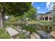 Picturesque backyard pond and bench seating with lush landscaping, offering a relaxing outdoor retreat at 10145 Meadow Run, Parker, CO 80134