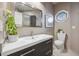 Bathroom featuring a white sink with a decorative backsplash, modern fixtures, and natural light at 10145 Meadow Run, Parker, CO 80134
