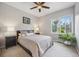 Bright bedroom featuring a ceiling fan, large window offering lots of natural light, and neutral decor at 10145 Meadow Run, Parker, CO 80134