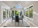 Bright dining room with triangular window, glass table, six chairs, and light wood flooring at 10145 Meadow Run, Parker, CO 80134