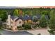 Charming home exterior with brick facade, well-manicured landscaping and a circular driveway at 10145 Meadow Run, Parker, CO 80134