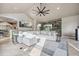 Spacious living room features vaulted ceilings, built-in bookcase and comfortable white sectional at 10145 Meadow Run, Parker, CO 80134