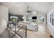 Open living room featuring a cozy fireplace, custom built-ins, and expansive windows with natural light at 10145 Meadow Run, Parker, CO 80134