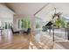 Bright living room with beautiful wood floors, vaulted ceilings, and large windows overlooking lush greenery at 10145 Meadow Run, Parker, CO 80134