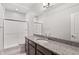 Bathroom featuring granite counters, glass enclosed shower, and neutral decor at 21097 E 62Nd Dr, Aurora, CO 80019