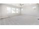 Expansive bedroom features plush carpet and multiple windows at 21097 E 62Nd Dr, Aurora, CO 80019