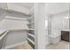 Spacious walk-in closet leading into a luxurious bathroom at 21097 E 62Nd Dr, Aurora, CO 80019
