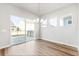 Bright dining area featuring sliding glass doors for easy outdoor access and stylish lighting at 21097 E 62Nd Dr, Aurora, CO 80019