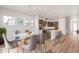 Open concept dining room with a glass table, modern chairs, and an adjacent kitchen at 21097 E 62Nd Dr, Aurora, CO 80019