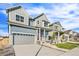 Street view of a modern two-story home with a two-car garage and landscaped front yard at 21097 E 62Nd Dr, Aurora, CO 80019