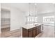 Kitchen island boasts an undermount sink, cabinet storage, and stylish pendant lighting at 21097 E 62Nd Dr, Aurora, CO 80019
