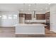 Gourmet kitchen with stainless steel appliances, a large island, and custom cabinetry at 21097 E 62Nd Dr, Aurora, CO 80019