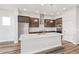 Modern kitchen with a large center island, stainless steel appliances, and stylish lighting at 21097 E 62Nd Dr, Aurora, CO 80019