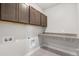 Convenient laundry room with countertop and overhead storage at 21097 E 62Nd Dr, Aurora, CO 80019