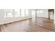 Open-concept living area featuring hardwood floors, large windows, and neutral color palette at 21097 E 62Nd Dr, Aurora, CO 80019
