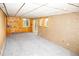 Spacious basement with plush carpeting, knotty-pine accents, and ample natural light from the egress window and glass door at 10554 Tanglewood Rd, Franktown, CO 80116