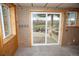 Basement featuring walkout access to backyard with pond; accented with natural knotty pine and neutral wall coverings at 10554 Tanglewood Rd, Franktown, CO 80116