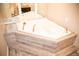 Bathroom highlighting a luxurious corner tub with tile surround and gold fixtures at 10554 Tanglewood Rd, Franktown, CO 80116