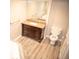 Bathroom featuring tile floors, wood vanity with granite top, and a toilet with an open linen closet at 10554 Tanglewood Rd, Franktown, CO 80116