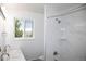 Bright bathroom featuring a window, double vanity with marble countertops and shower stall with modern white tiling at 10554 Tanglewood Rd, Franktown, CO 80116