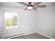 Inviting bedroom with carpet, ceiling fan, and a large window offering outdoor views at 10554 Tanglewood Rd, Franktown, CO 80116