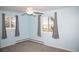 Bedroom featuring carpet, ceiling fan, and two windows offering pleasant views and natural light at 10554 Tanglewood Rd, Franktown, CO 80116