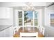 Sunlit dining area with a large window offering scenic views and stylish antler chandelier at 10554 Tanglewood Rd, Franktown, CO 80116