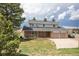 Charming two-story home with a brick facade and a well-maintained front yard and a two car garage at 10554 Tanglewood Rd, Franktown, CO 80116