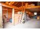 Spacious garage with high ceilings, lofted storage, and ladder access at 10554 Tanglewood Rd, Franktown, CO 80116