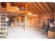 Garage offering ample storage space with open wood beam ceilings and walls featuring a loft at 10554 Tanglewood Rd, Franktown, CO 80116