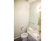 Traditional half bathroom with a marble countertop, white toilet, and a minimalist mirror at 10554 Tanglewood Rd, Franktown, CO 80116
