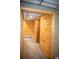 Wood paneled hallway featuring wood paneled walls, carpeted floors, and paneled doorways at 10554 Tanglewood Rd, Franktown, CO 80116