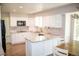 Bright kitchen features white cabinetry, stainless steel appliances, granite countertops, and a breakfast bar at 10554 Tanglewood Rd, Franktown, CO 80116