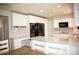 Modern white kitchen with stainless steel appliances, granite countertops, and ample cabinet space at 10554 Tanglewood Rd, Franktown, CO 80116
