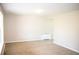 Bright living room with neutral carpet, fresh paint, and baseboard heating at 10554 Tanglewood Rd, Franktown, CO 80116