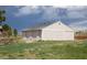 Outbuilding featuring metal sliding doors, a gray shingle roof, and neutral horizontal siding at 10554 Tanglewood Rd, Franktown, CO 80116