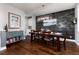 Chic dining area with a vibrant blue accent cabinet and a view of the adjoining kitchen space at 15415 Carob Cir, Parker, CO 80134