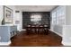 Elegant dining room featuring a modern chandelier, dark wood table set, and a stylish accent wall at 15415 Carob Cir, Parker, CO 80134